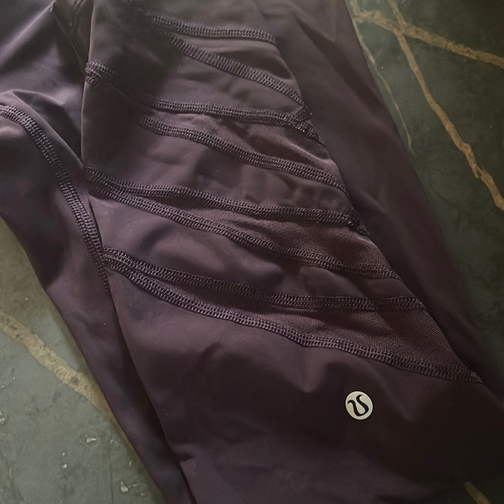 Lululemon dark purple leggings w/ sheer design on lower part of leggings. Size 8